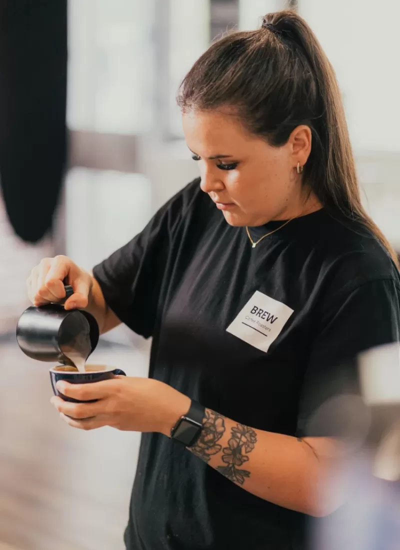 Brew Coffee Roasters Perth female barista pouring coffee into mug