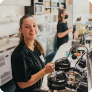 Smiling Barista serving up delicious Perth coffee beans