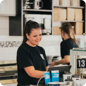 Smiling Barista serving up delicious Perth coffee beans