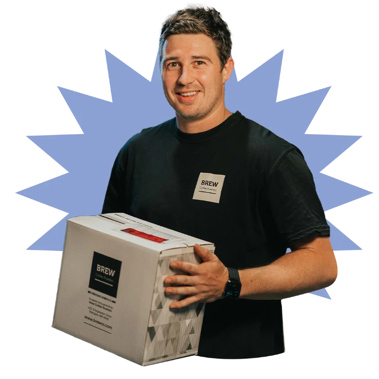Brew Coffee employee holding a box of coffee beans