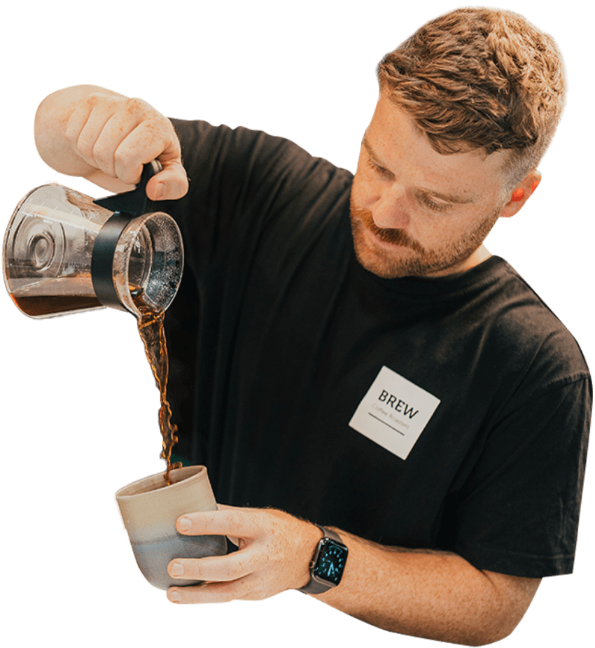 Barista pouring our freshly brewed, award-winning coffee beans from Brew Coffee Roasters