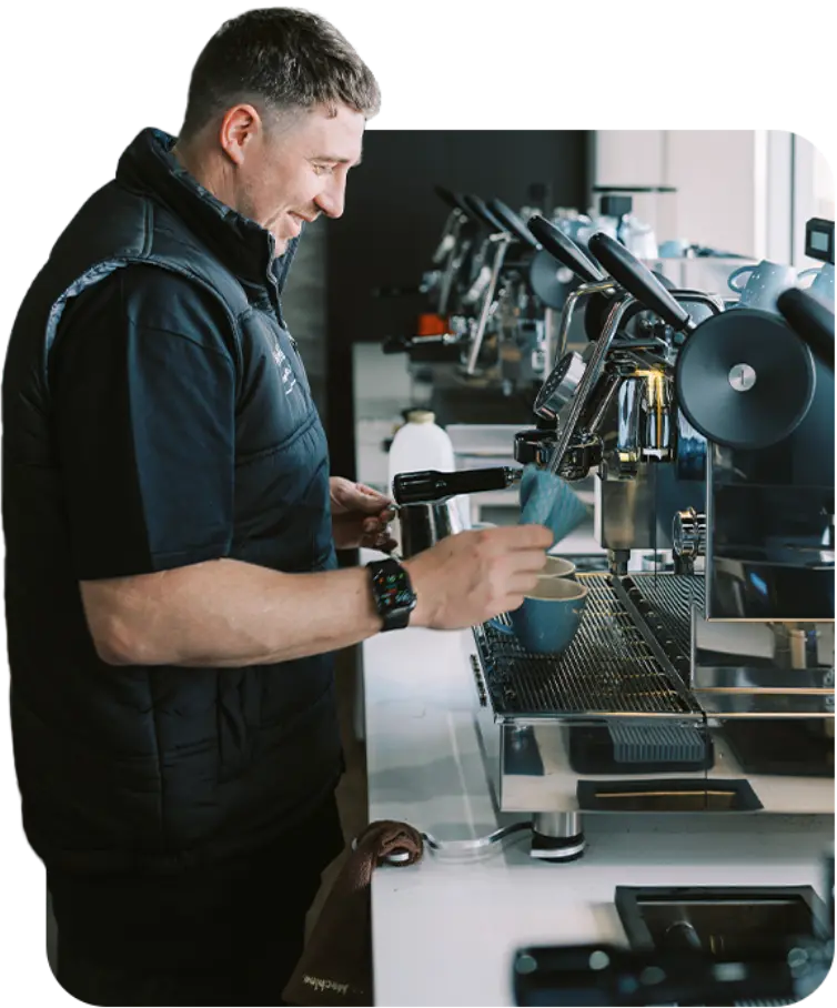male barista using coffee equipment available at Brew Coffee Roasters
