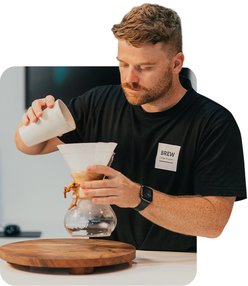 A barista pouring coffee at Brew Coffee Roasters Perth